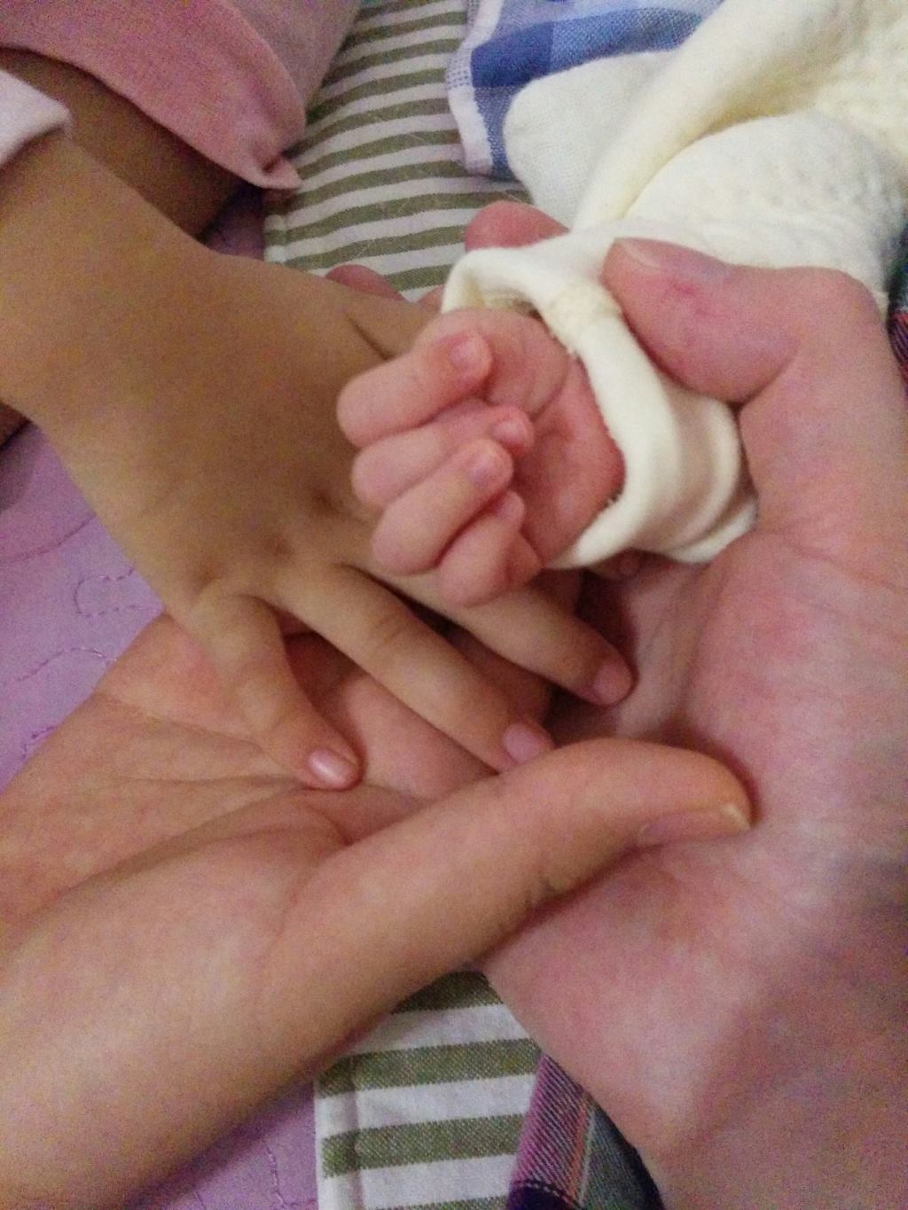 Big hands holding small hands